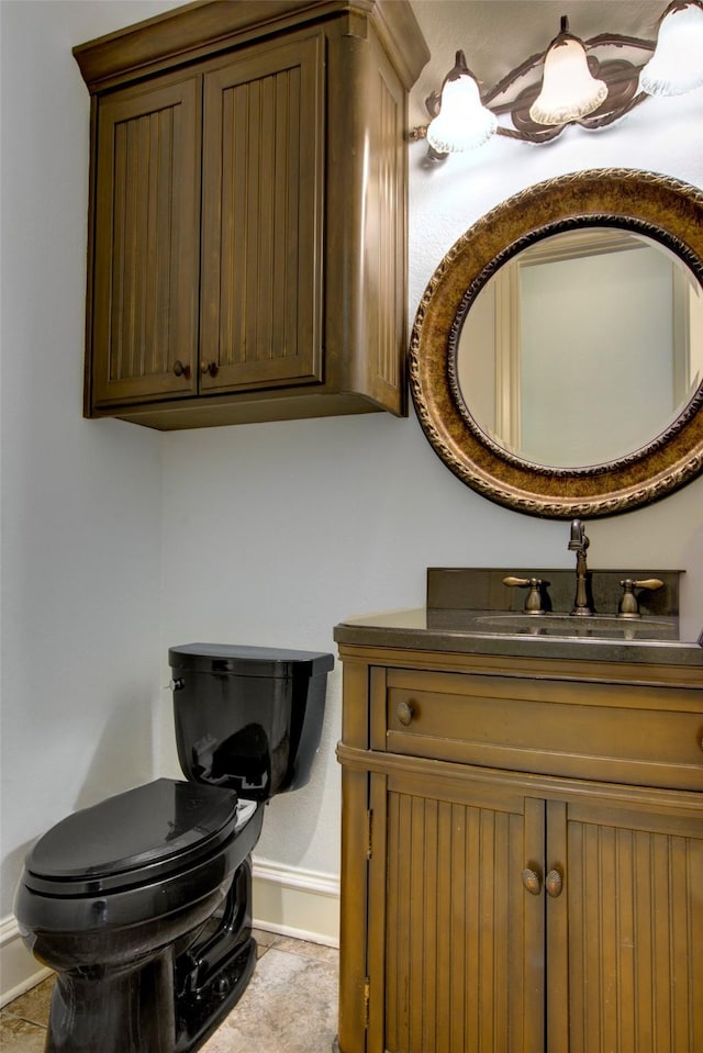 bathroom featuring toilet and vanity