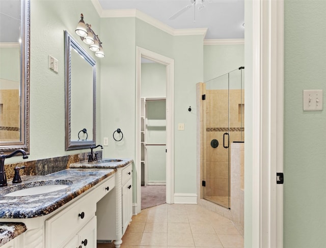 bathroom with an enclosed shower, ceiling fan, tile patterned floors, ornamental molding, and vanity