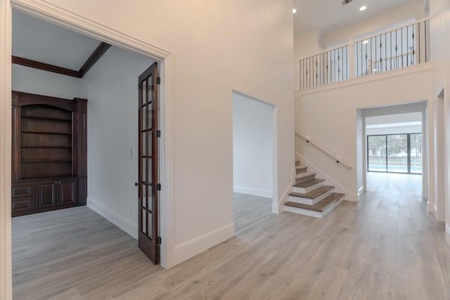 interior space featuring wood-type flooring and ornamental molding