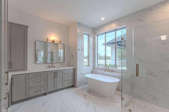 bathroom with vanity, separate shower and tub, and a healthy amount of sunlight