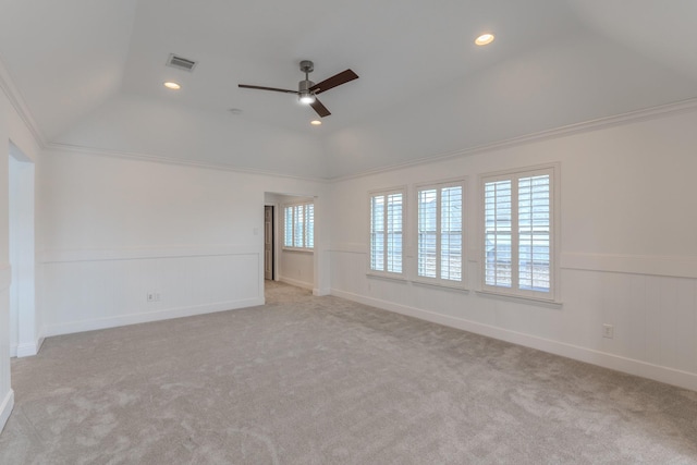 carpeted empty room featuring crown molding, lofted ceiling, and ceiling fan