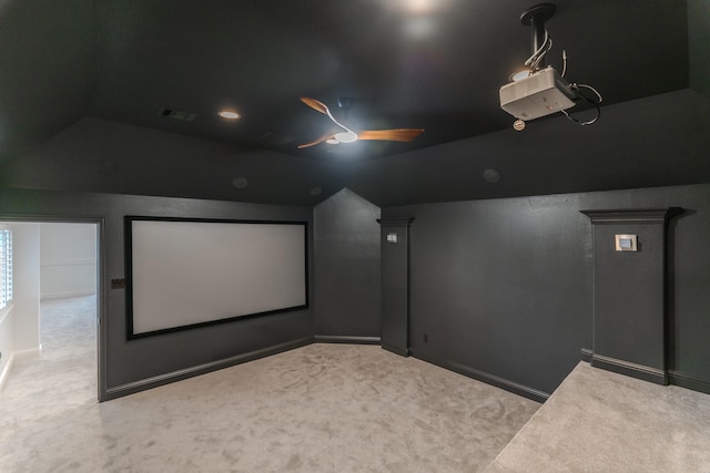 carpeted cinema room with vaulted ceiling and ceiling fan