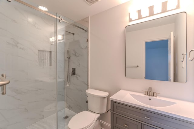 bathroom with vanity, walk in shower, and toilet