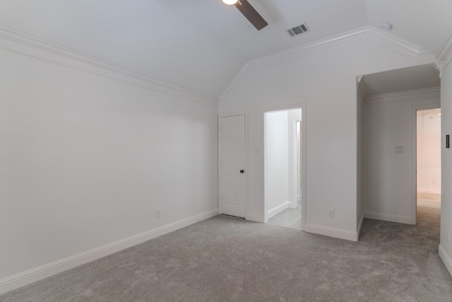 unfurnished room featuring vaulted ceiling, light carpet, ceiling fan, and crown molding