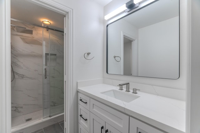 bathroom featuring vanity, a shower with shower door, and tile patterned flooring