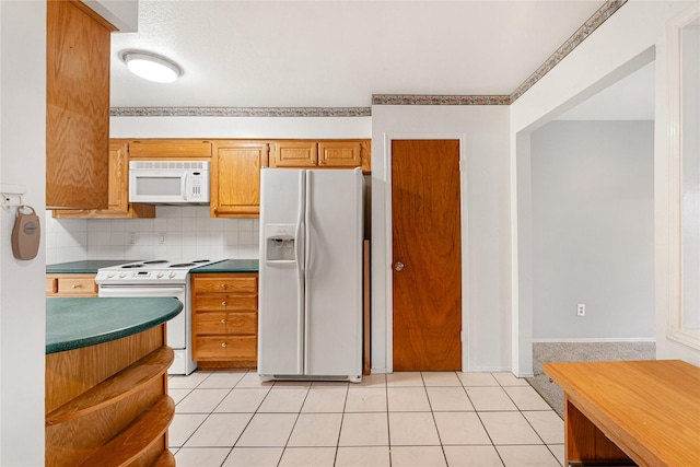 kitchen with white appliances, decorative backsplash, and light tile patterned floors