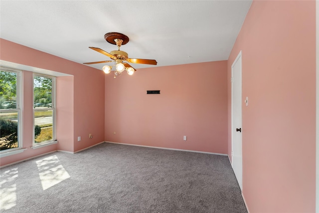 carpeted spare room featuring ceiling fan