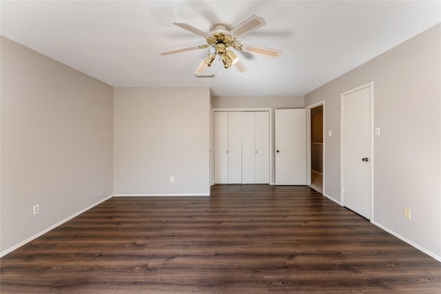 unfurnished bedroom featuring dark wood-type flooring and ceiling fan