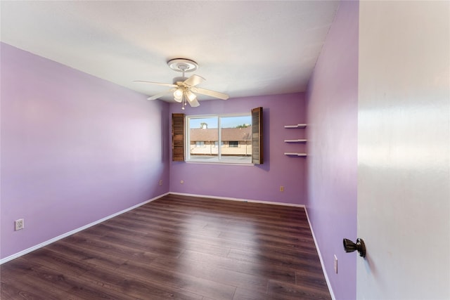 empty room featuring ceiling fan and dark hardwood / wood-style flooring