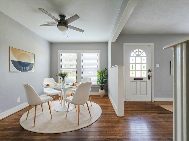 dining space featuring dark wood-type flooring and ceiling fan