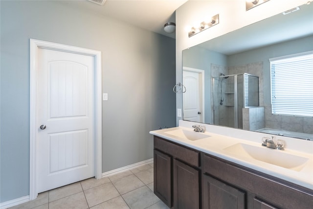 bathroom featuring tile patterned flooring, vanity, and shower with separate bathtub