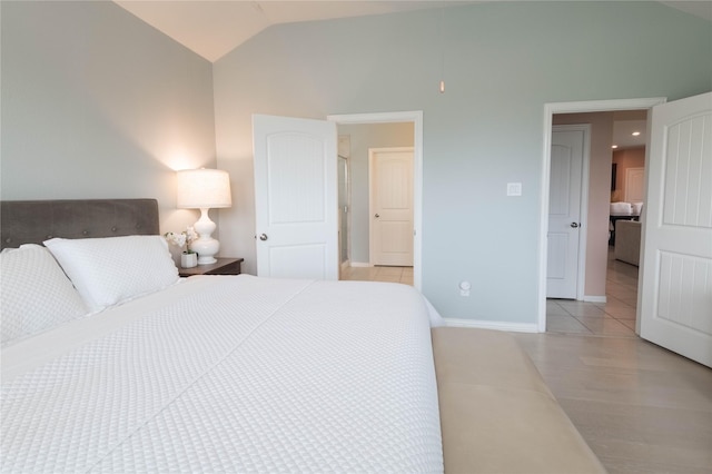 tiled bedroom featuring lofted ceiling