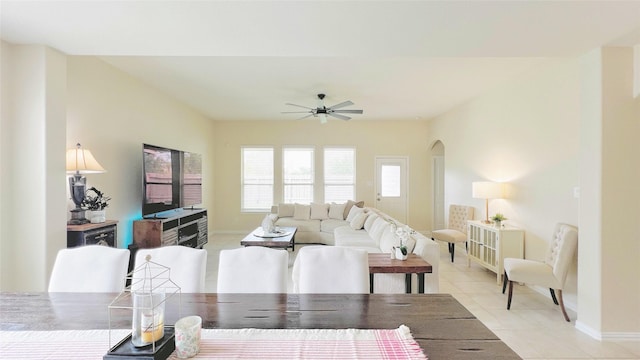 tiled living room with ceiling fan