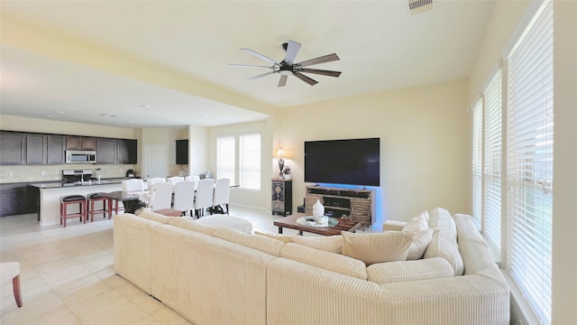 living room with ceiling fan and light tile patterned floors