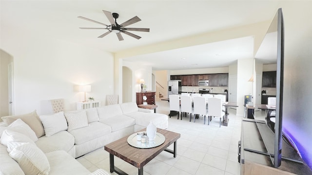 tiled living room with ceiling fan