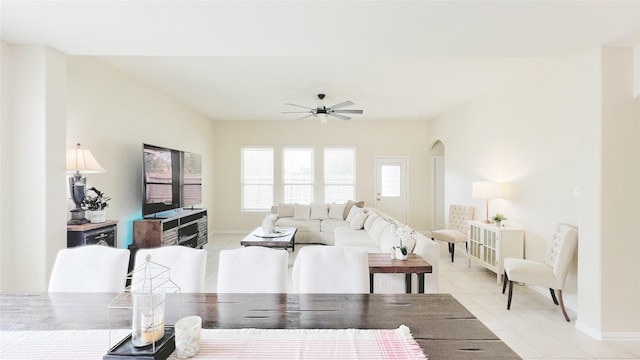 tiled living room with ceiling fan