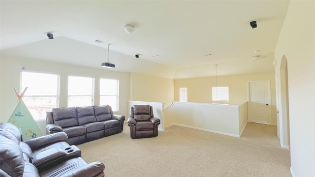 carpeted living room with lofted ceiling