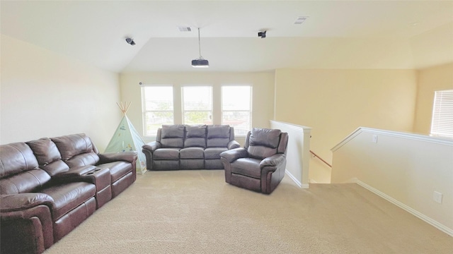 carpeted living room with vaulted ceiling