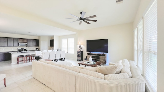 living room with ceiling fan and light tile patterned flooring