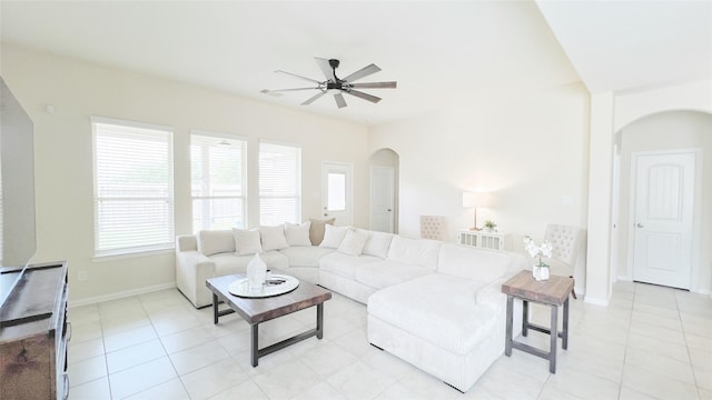 tiled living room with ceiling fan