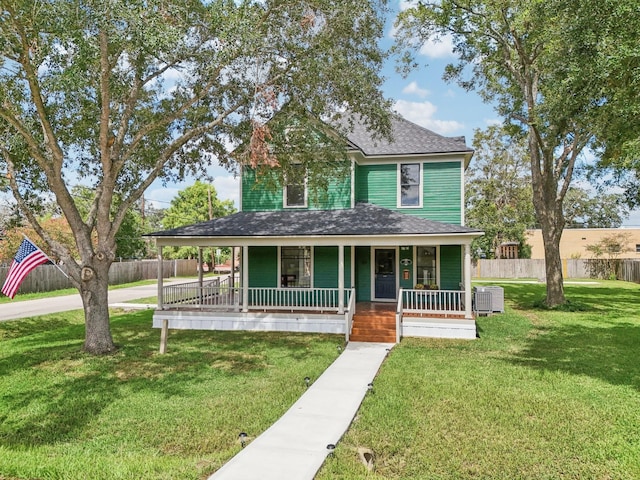 country-style home with covered porch, cooling unit, and a front lawn