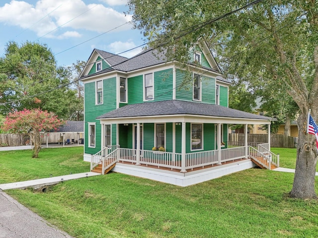 view of front of property with covered porch and a front yard