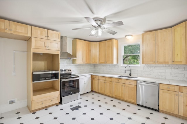 kitchen with wall chimney exhaust hood, light brown cabinets, sink, and stainless steel appliances