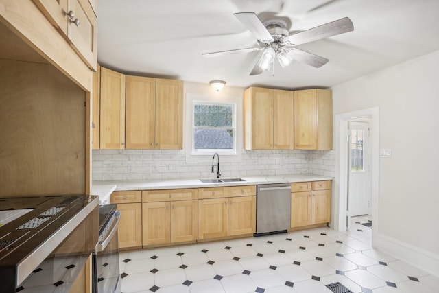 kitchen with sink, light brown cabinetry, dishwasher, and ceiling fan