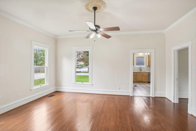 unfurnished room featuring ceiling fan, dark hardwood / wood-style flooring, and ornamental molding