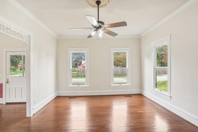 empty room featuring wood-type flooring, ceiling fan, and ornamental molding