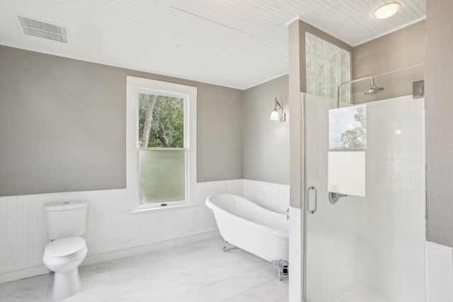 bathroom featuring toilet and shower with separate bathtub