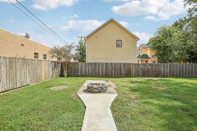 view of yard with a fire pit