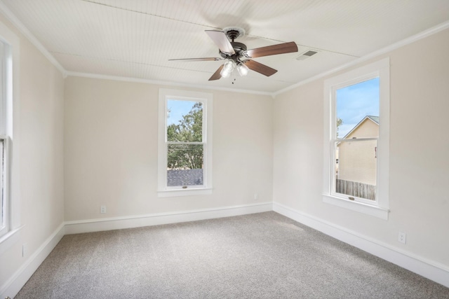 empty room with ceiling fan, ornamental molding, and carpet floors