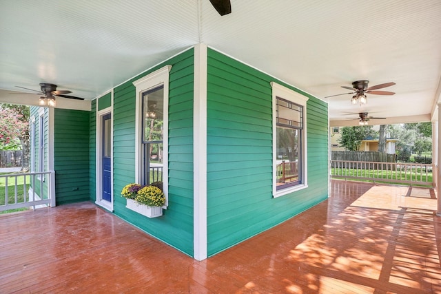 wooden terrace featuring a porch and ceiling fan