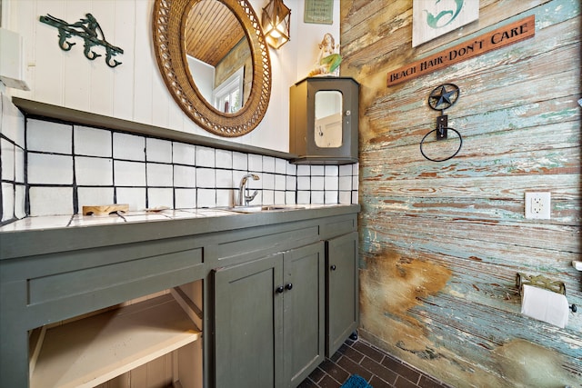 bathroom with vanity, decorative backsplash, and wood walls