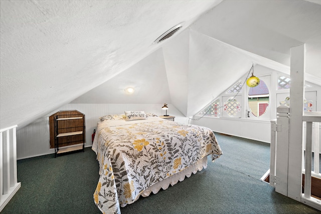 carpeted bedroom featuring vaulted ceiling and a textured ceiling