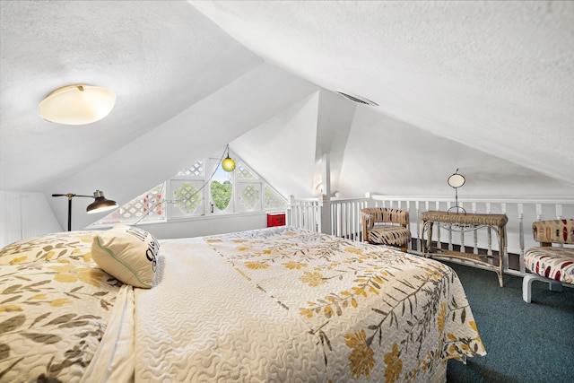 bedroom with lofted ceiling, carpet floors, and a textured ceiling