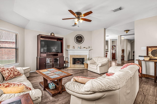 living room with ceiling fan, hardwood / wood-style floors, a fireplace, and lofted ceiling