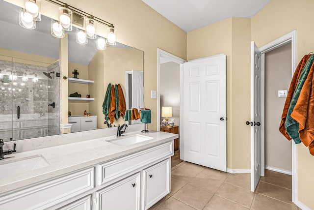 bathroom featuring tile patterned floors, a shower with door, and vanity