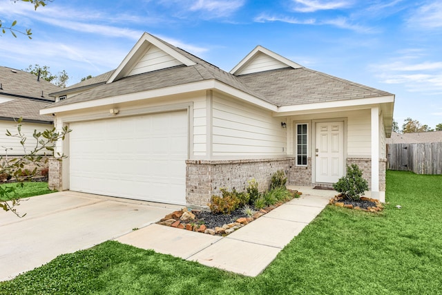 view of front of property featuring a garage and a front lawn