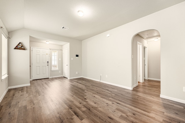 interior space with hardwood / wood-style floors and vaulted ceiling