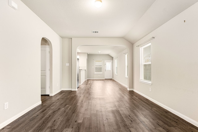 hall with dark wood-type flooring and lofted ceiling