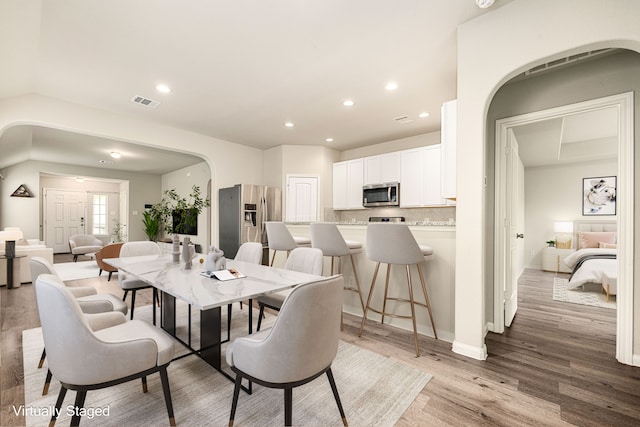 dining area with light hardwood / wood-style floors