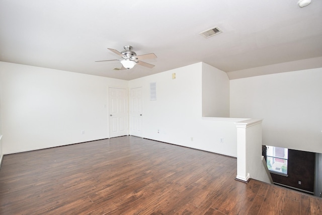 unfurnished living room featuring dark hardwood / wood-style floors and ceiling fan