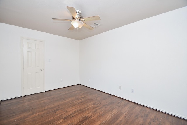 empty room with ceiling fan and dark hardwood / wood-style flooring