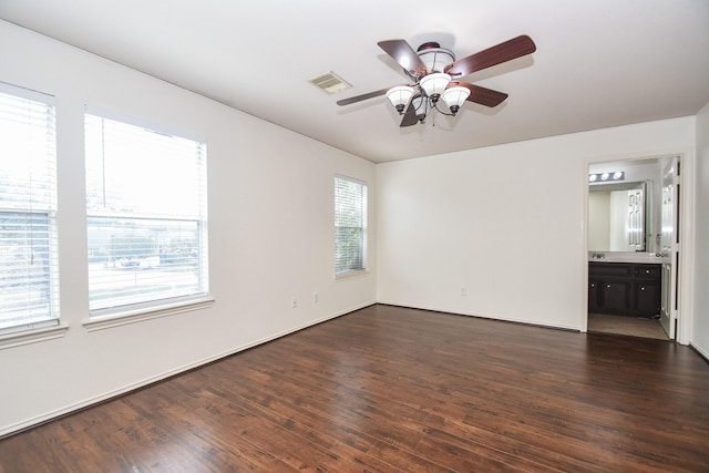 unfurnished room featuring ceiling fan and dark wood-type flooring