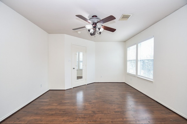 empty room with ceiling fan and dark hardwood / wood-style floors