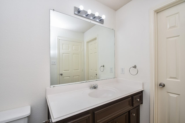 bathroom featuring toilet and vanity