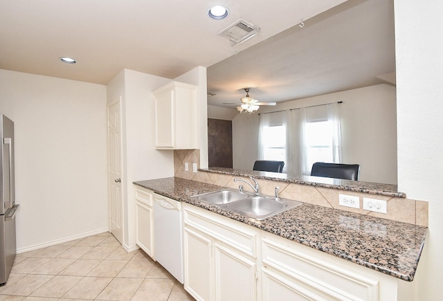 kitchen featuring dishwasher, stainless steel refrigerator, light tile patterned floors, sink, and ceiling fan