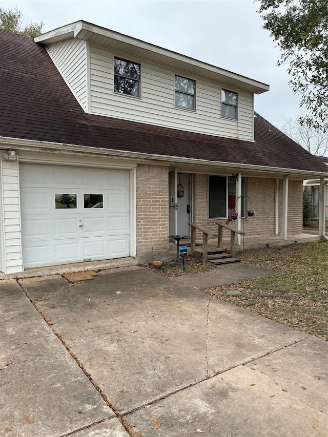 view of front of property with a porch and a garage